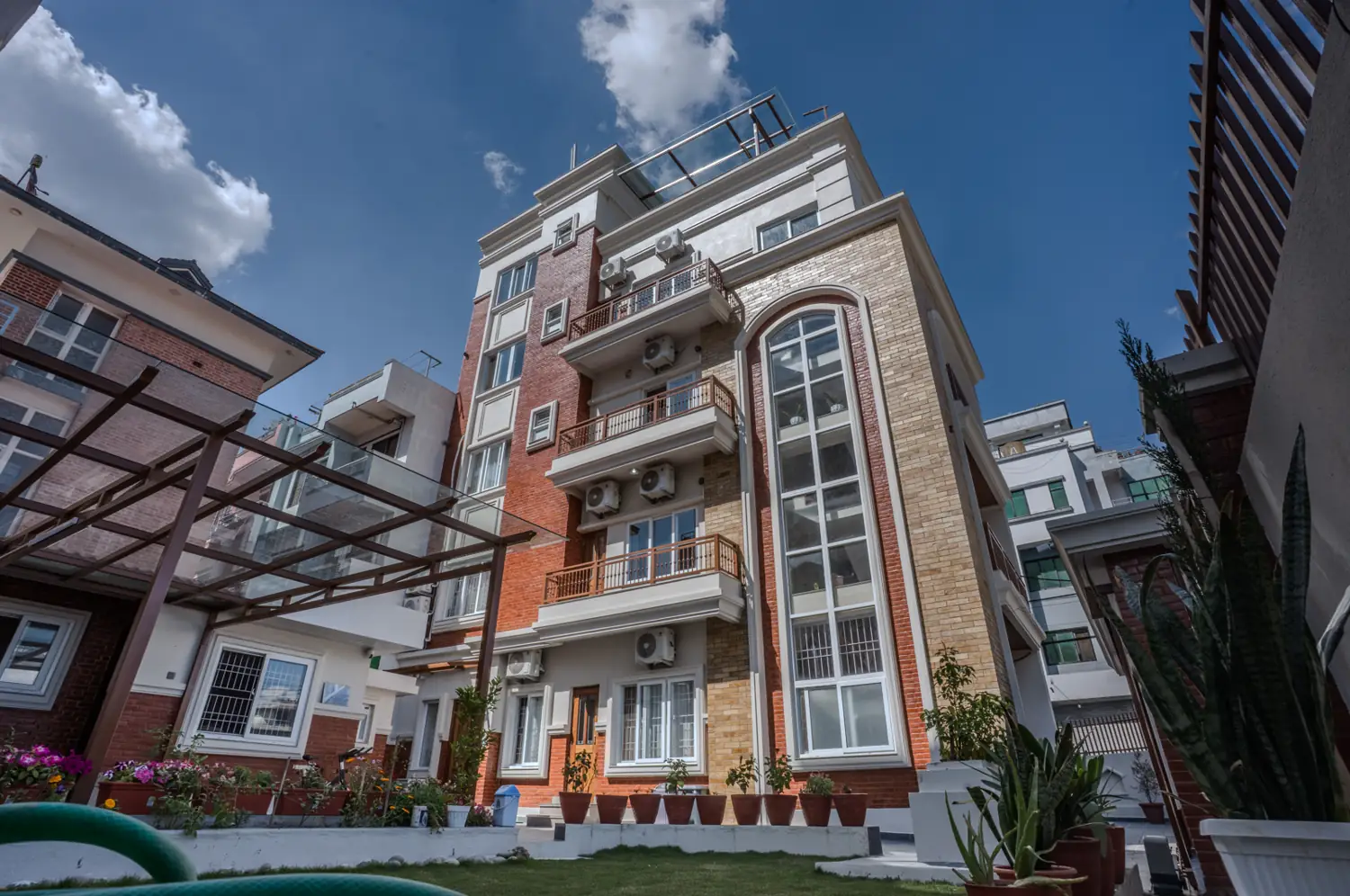 Red-brick facade with arched glass stair tower