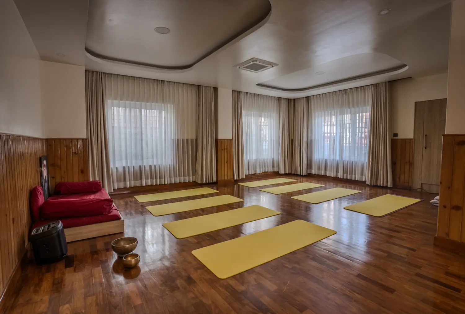 Meditation hall with mats and singing bowls